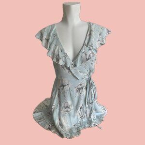 Soft and romantic wrap mini dress in a pale blue floral print by Free People